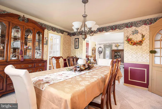a view of a dining room with furniture and a chandelier