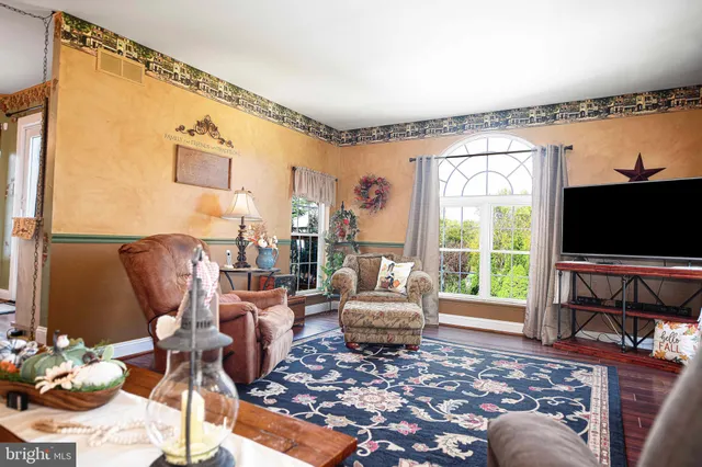 a living room with furniture a fireplace and a flat screen tv