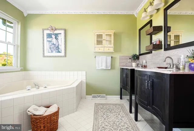 a bedroom with a large bed and a potted plant