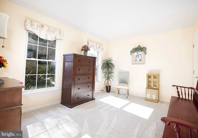 a living room with a table and chairs