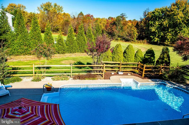 a view of a cafe with a table and chairs under an umbrella