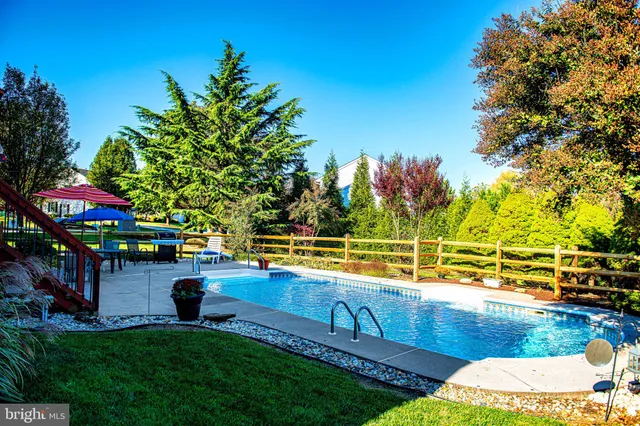 an outdoor space with swimming pool and furniture