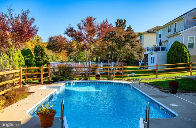 a swimming pool with outdoor seating and yard