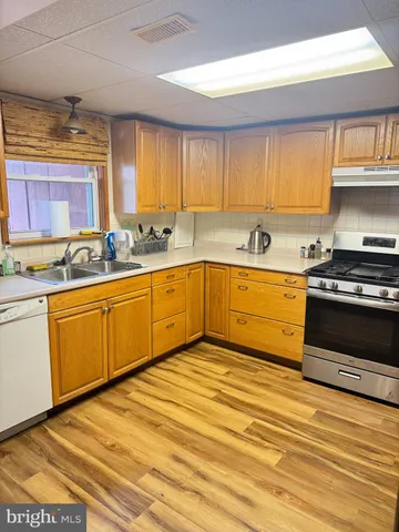 a kitchen with stainless steel appliances granite countertop a sink and cabinets