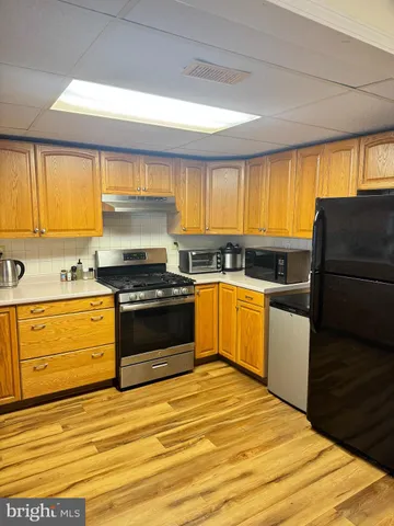 a kitchen with granite countertop a stove a sink and a window