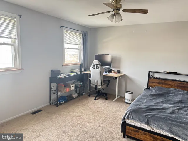 a bedroom with a workspace