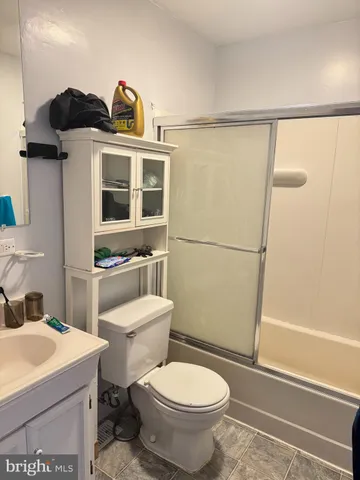 a bathroom with a toilet a sink and a shower