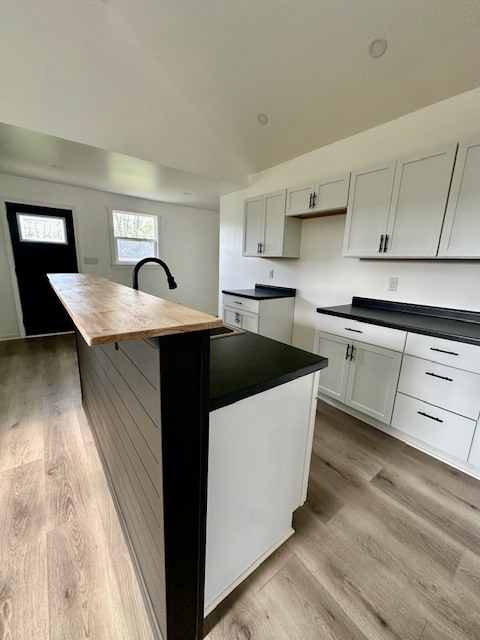527 12th Street Peru, IL 61354 - Photo 6 of 15 a kitchen with stainless steel appliances a sink dishwasher a stove a refrigerator and cabinets with wooden floor