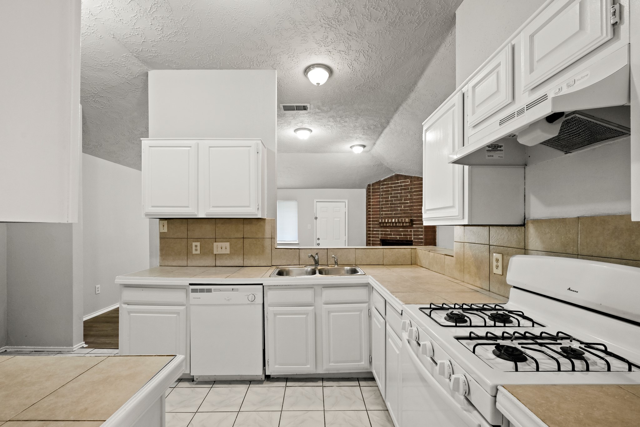 6607 Navidad Road Houston, TX 77083 - Photo 2 of 11 a kitchen with cabinets appliances and a counter top space