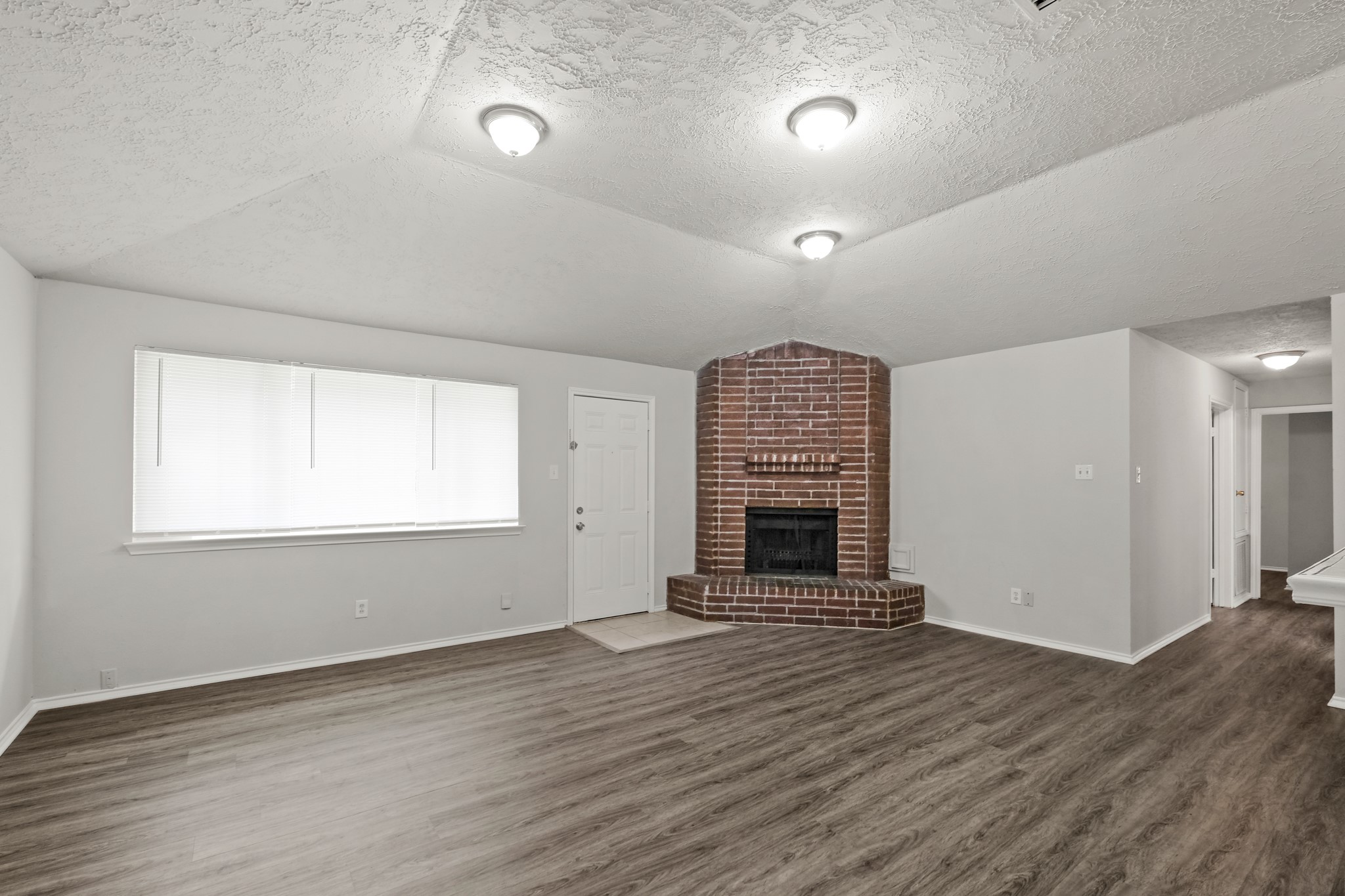 6607 Navidad Road Houston, TX 77083 - Photo 5 of 11 an empty room with windows and entrance