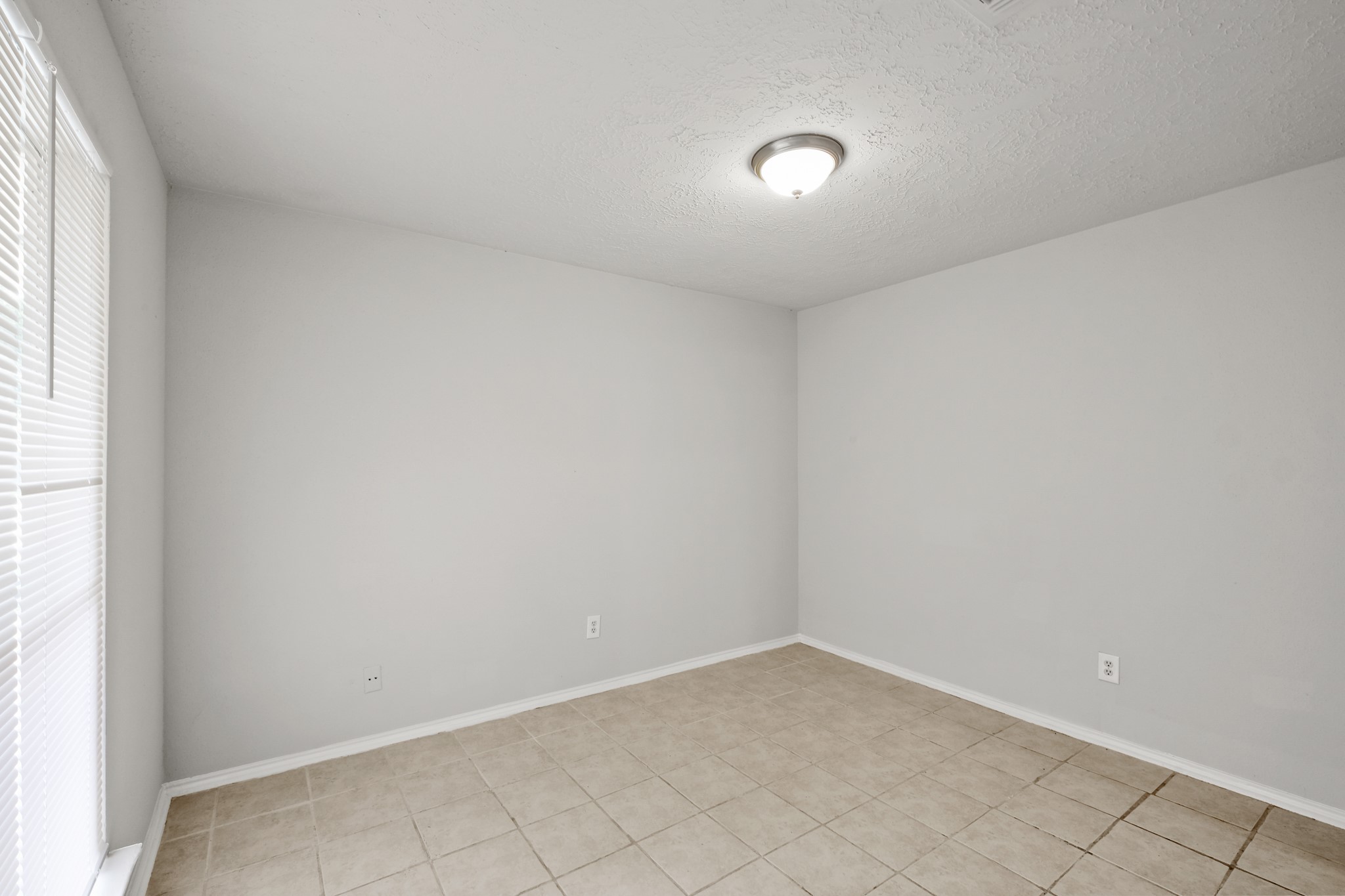 6607 Navidad Road Houston, TX 77083 - Photo 8 of 11 a view of an empty room and window