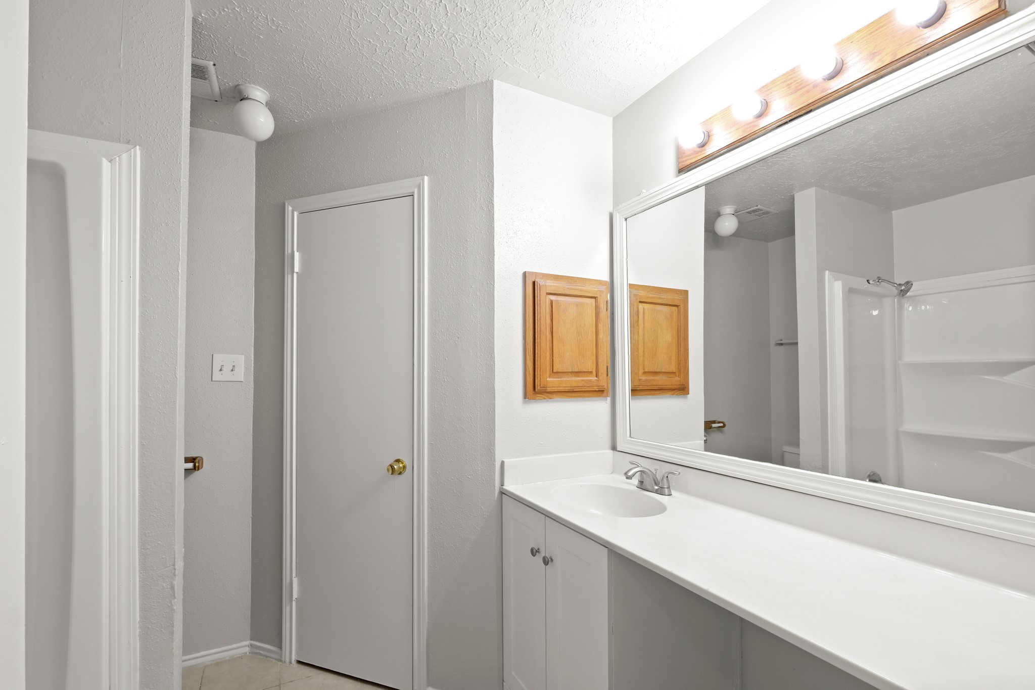 6607 Navidad Road Houston, TX 77083 - Photo 9 of 11 a bathroom with a sink and a mirror