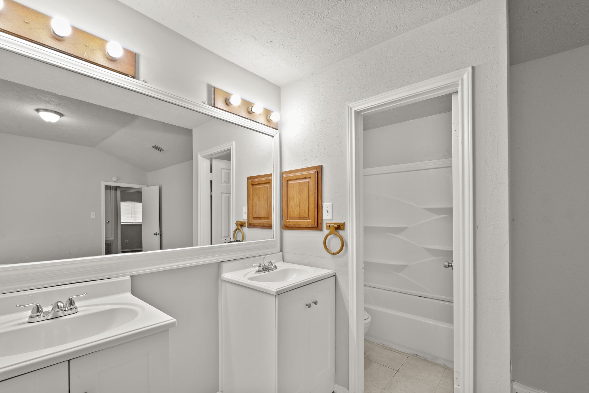 6607 Navidad Road Houston, TX 77083 - Photo 10 of 11 a bathroom with a sink and a mirror