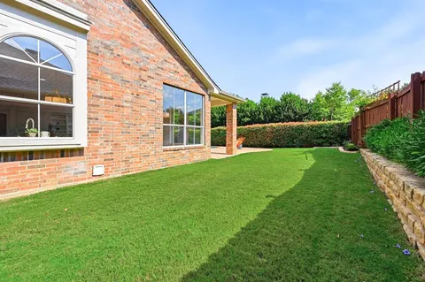 a view of house with backyard