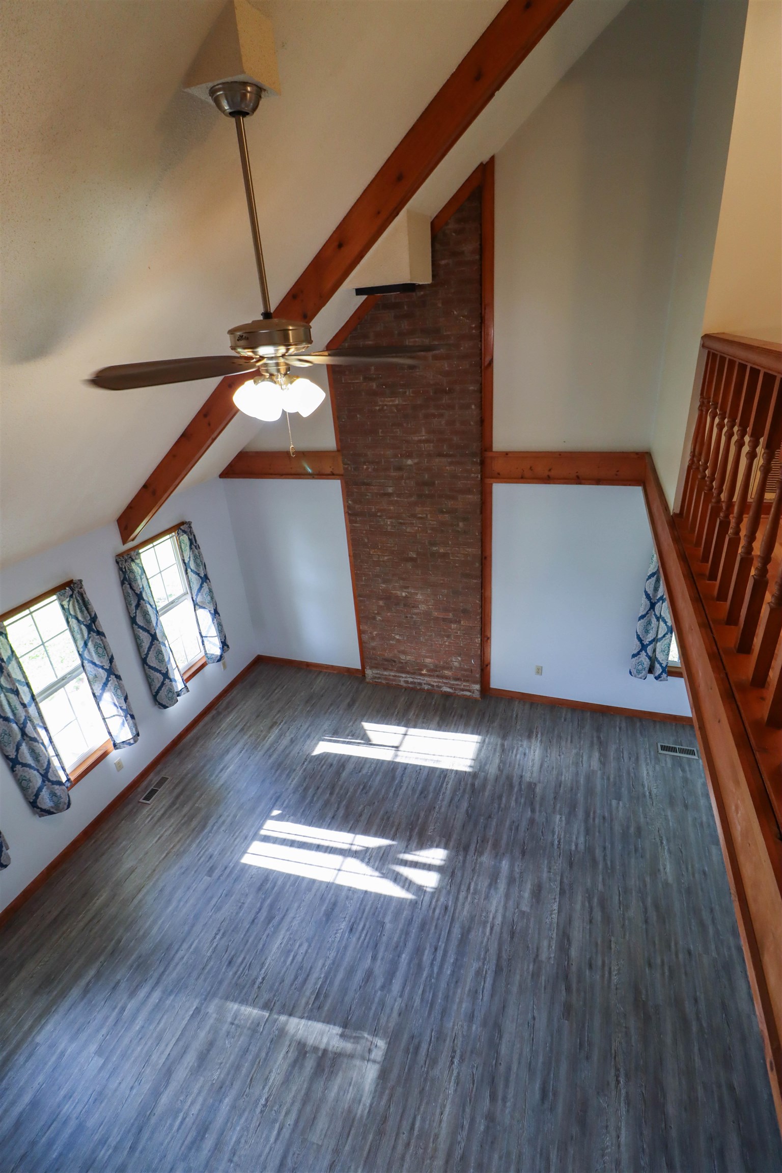 190 Craig Road Ripley, TN 38063 - Photo 26 of 40 a view of an empty room with wooden floor and a ceiling fan