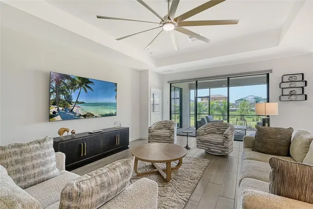 a living room with furniture and a floor to ceiling window