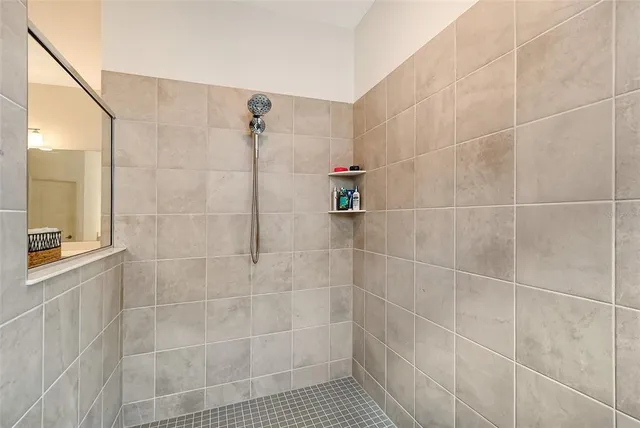 a view of a big yard with potted plants and large tree