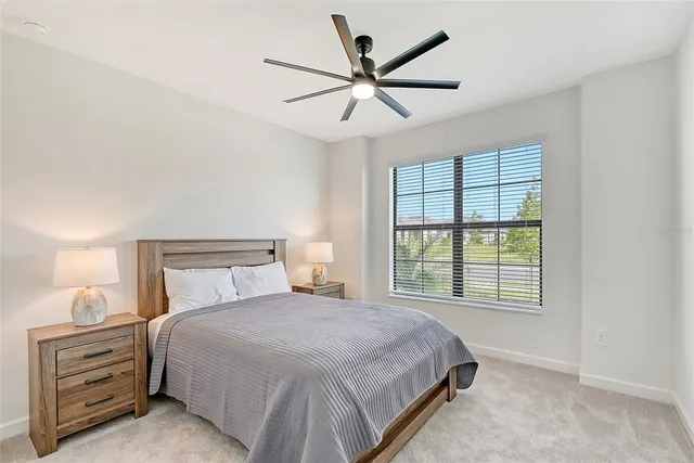 a living room with furniture a flat screen tv and a large window