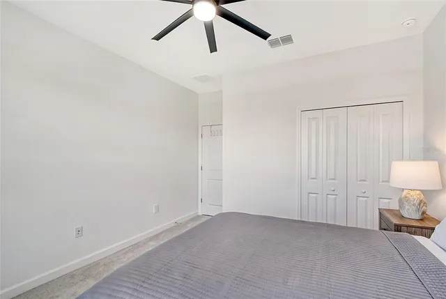 a living room with furniture a flat screen tv and a large window