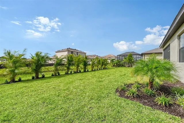 a view of a swimming pool with an ocean and houses in the back