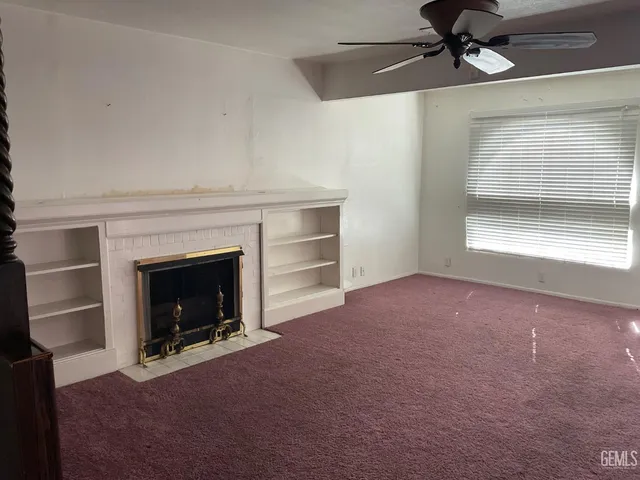 a kitchen with a refrigerator and white cabinets