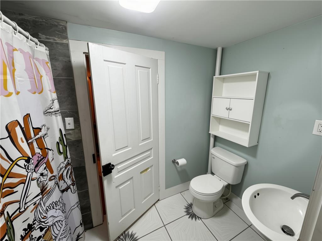 108 Effort Neola Road Effort, PA 18330 - Photo 12 of 31 A compact full bathroom featuring tile flooring and a functional storage cabinet.