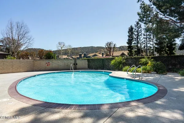 a view of a swimming pool with a yard