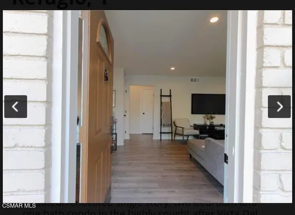 a view of living room filled with furniture and flat screen tv