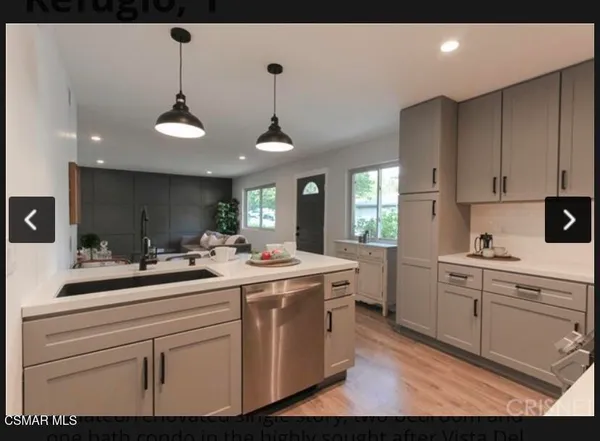 a kitchen with a sink stainless steel appliances and cabinets