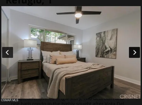 a bedroom with a bed and a painting on the wall