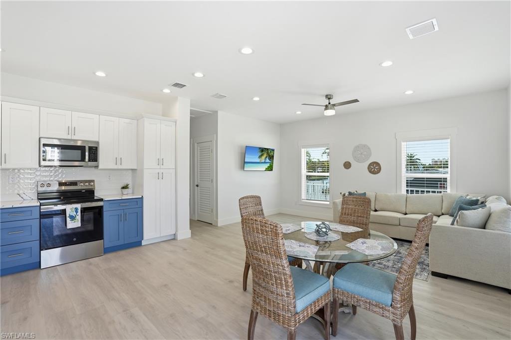 1 Fairview Boulevard Fort Myers Beach, FL 33931 - Photo 11 of 48 Open-concept living area featuring light wood-finish flooring, recessed lighting, and a ceiling fan - Virtually Edited Image