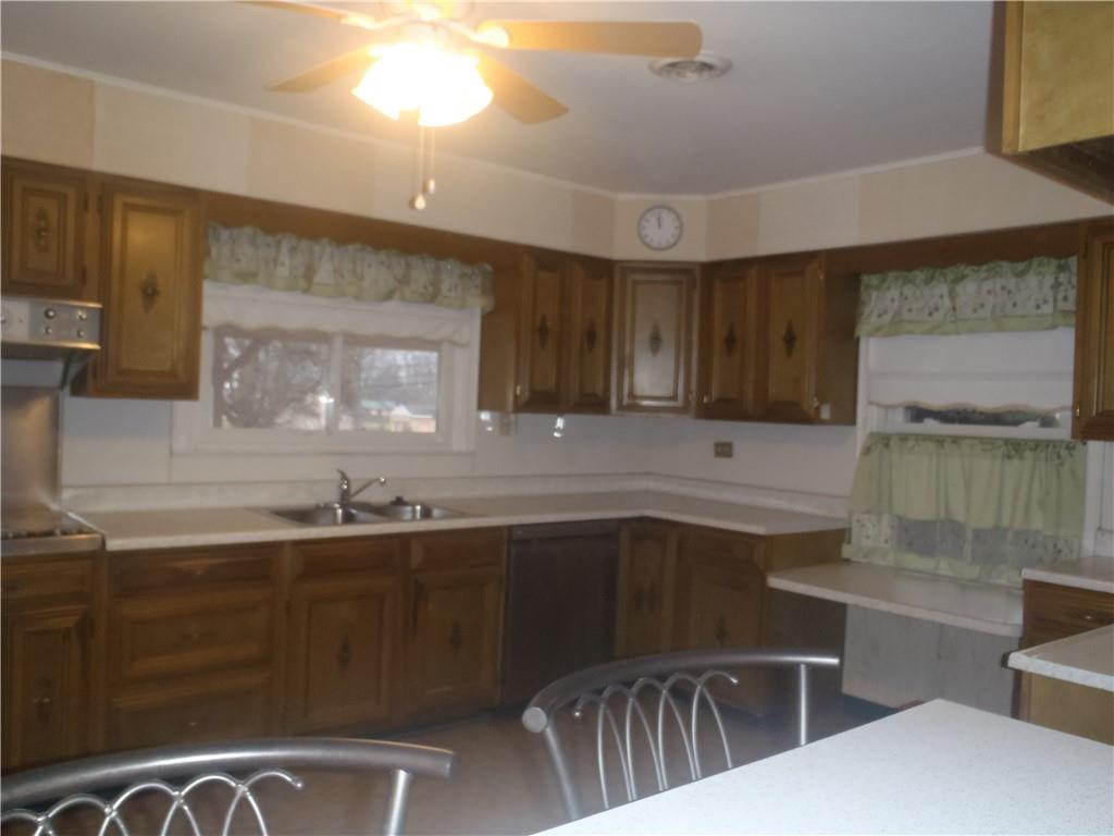 2614 Old Pittsburgh Road New Castle, PA 16101 - Photo 4 of 16 a kitchen with stainless steel appliances a sink stove and cabinets