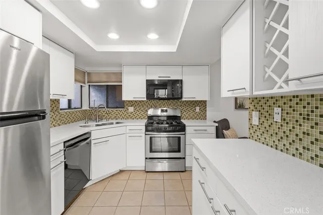 a kitchen with granite countertop a stove and a sink
