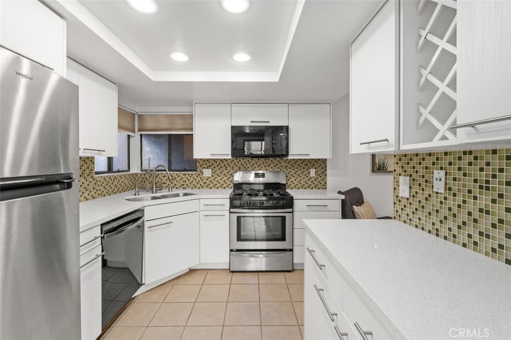 28101 Montecito, Unit 15 Laguna Niguel, CA 92677 - Photo 12 of 44 a kitchen with granite countertop a stove and a sink