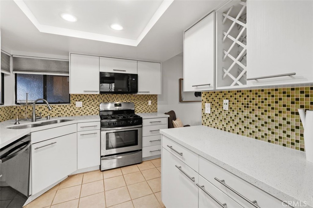 28101 Montecito, Unit 15 Laguna Niguel, CA 92677 - Photo 13 of 44 a kitchen with a sink and a stove top oven