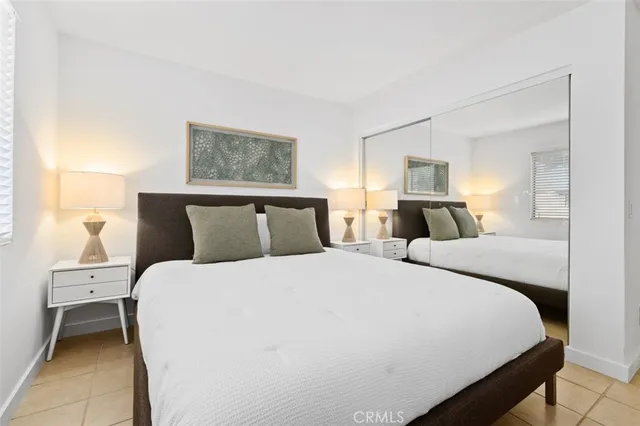 a bedroom with a bed and a chair