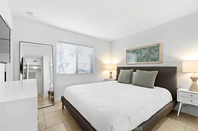 a bedroom with a large bed and a window