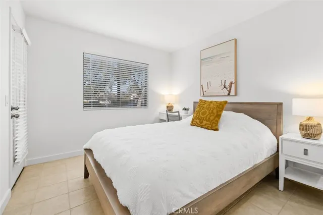 a bedroom with a bed and window