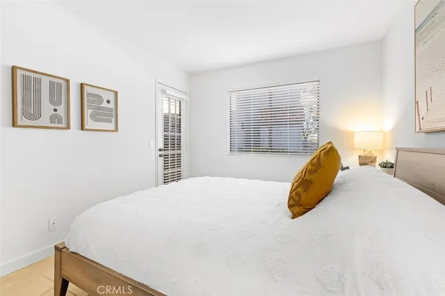 a bed sitting in a bedroom next to a window