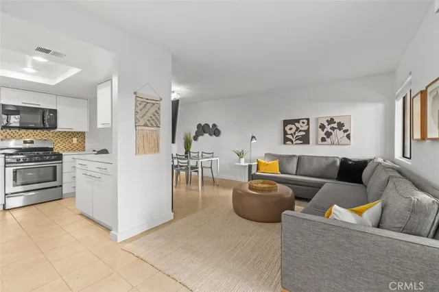 a living room with furniture and kitchen view