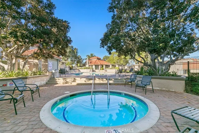 a view of a swimming pool with outdoor seating