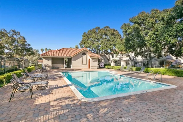a view of a house with swimming pool and sitting area