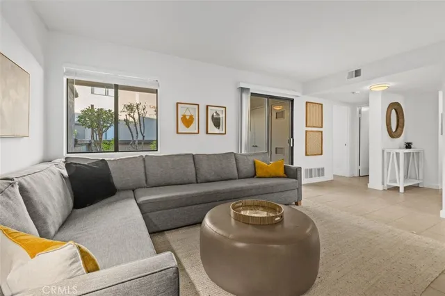 a living room with furniture window and a couch