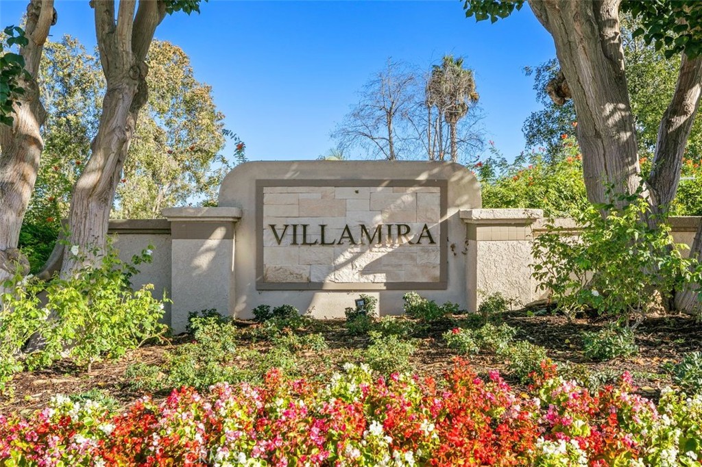 28101 Montecito, Unit 15 Laguna Niguel, CA 92677 - Photo 42 of 44 a view of a sign board with flower plants and wooden fence