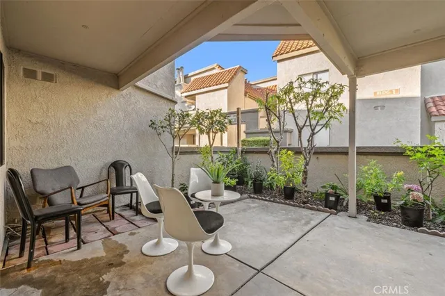 a view of a patio with table and chairs and potted plants