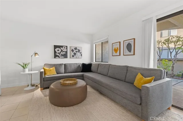 a living room with furniture and painting on the wall