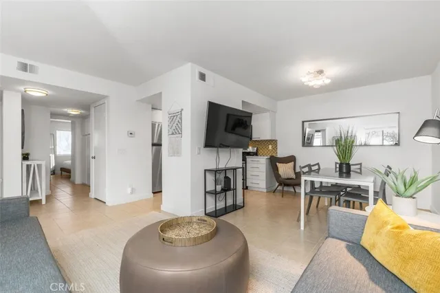 a living room with fireplace furniture and a flat screen tv
