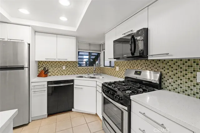 a kitchen with a stove and a refrigerator