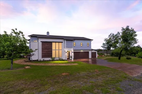 a view of a house with a yard and sitting area