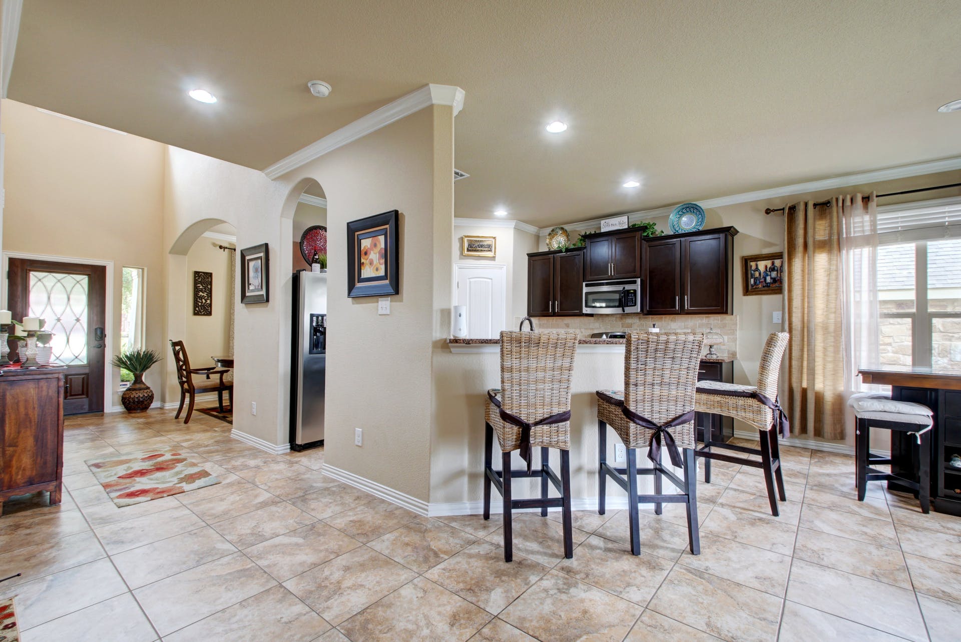 2004 Autumn Run Lane Round Rock, TX 78665 - Photo 6 of 37 An inviting open-concept layout features rich cabinetry and tile flooring throughout, perfect for gatherings.